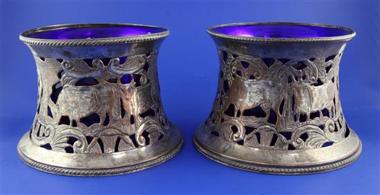 A near pair of 19th century pierced silver plated dish rings with blue glass liners, height 5.5in.